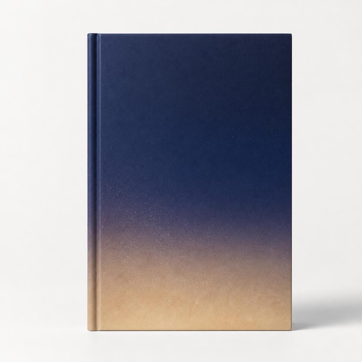 Indigo to sand gradient hardcover book standing upright against a clean studio background