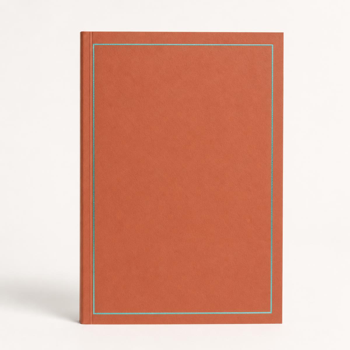 Terracotta softcover guided journal photographed straight on against a clean studio background