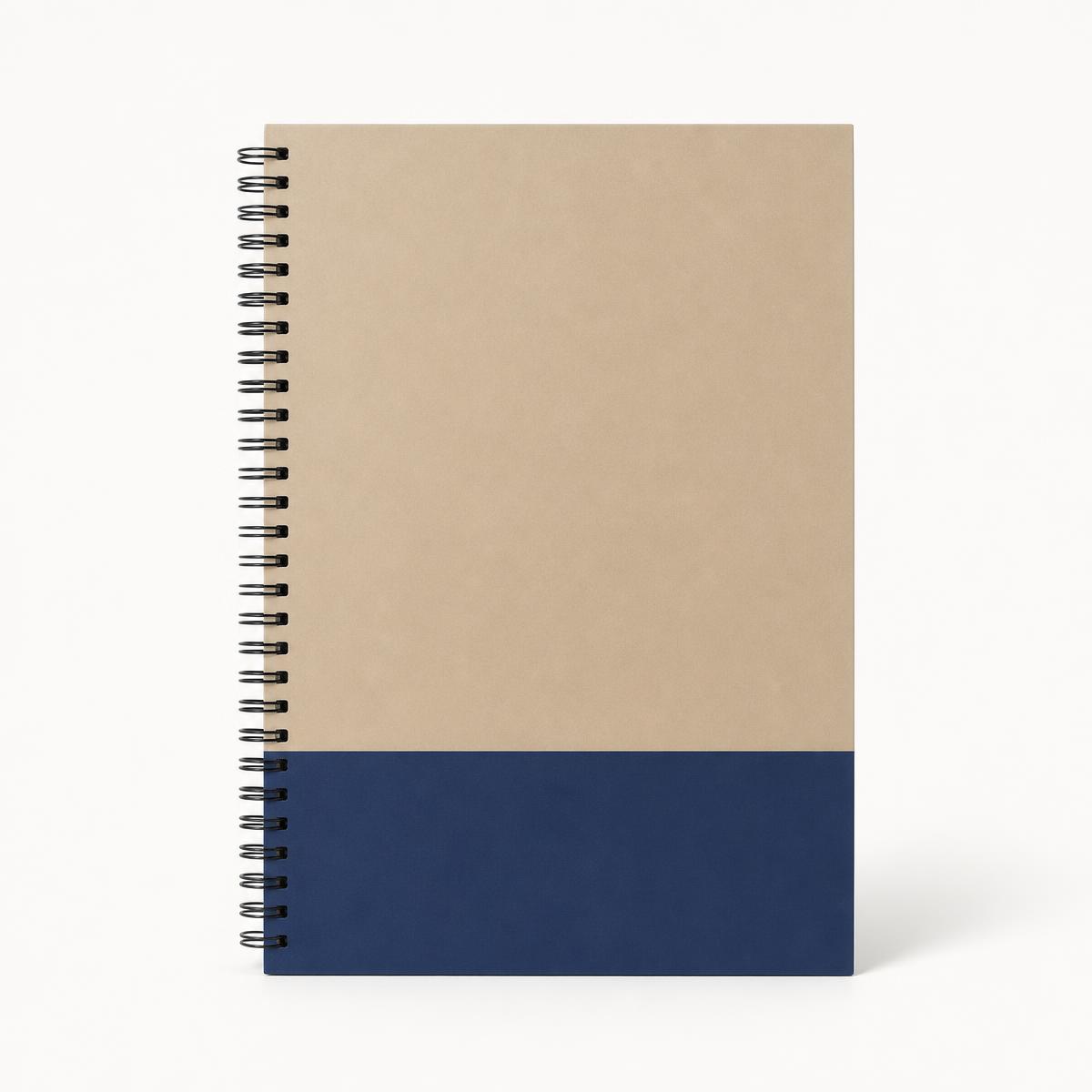 Spiral-bound sand and indigo quick reference guide standing upright on a studio background